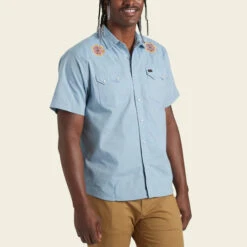 HOWLER MEN'S Crosscut Deluxe Shortsleeve Shirt -Johnny Corral Shop S23 SS Shirts Crosscut Deluxe SS Beach Blooms Blue Chambray Front 58c75713 f08d 4bf3 98b8 f1f03f2b03de